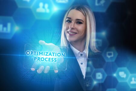 The concept of business, technology, the Internet and the network. A young entrepreneur working on a virtual screen of the future and sees the inscription: Optimization processの写真素材