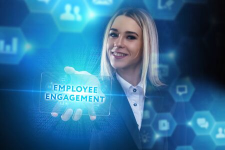 The concept of business, technology, the Internet and the network. A young entrepreneur working on a virtual screen of the future and sees the inscription: Employee engagementの写真素材