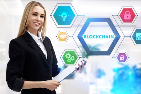 The concept of business, technology, the Internet and the network. A young entrepreneur working on a virtual screen of the future and sees the inscription: Blockchainの写真素材