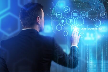 The concept of business, technology, the Internet and the network. A young entrepreneur working on a virtual screen of the future and sees the inscription: Cryptocurrencyの写真素材