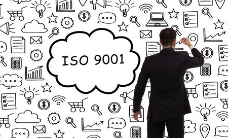 Business, technology, internet and networking concept. Young entrepreneur showing keyword: ISO 9001の写真素材