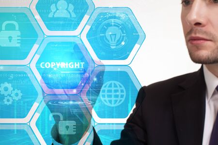 The concept of business, technology, the Internet and the network. A young entrepreneur working on a virtual screen of the future and sees the inscription: Copyrightの写真素材
