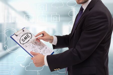 The concept of business, technology, the Internet and the network. A young entrepreneur working on a virtual screen of the future and sees the inscription: SMEの写真素材