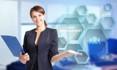 The concept of business, technology, the Internet and the network. A young entrepreneur working on a virtual screen of the future and sees the inscription: Asset managementの写真素材