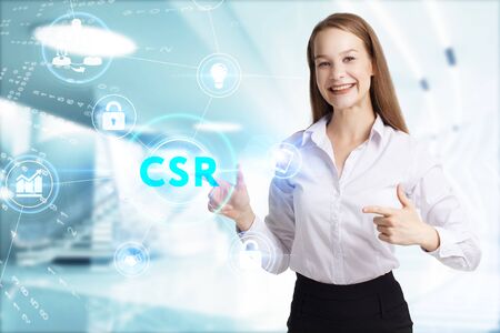 Business, Technology, Internet and network concept. Young businessman working on a virtual screen of the future and sees the inscription: CSRの写真素材