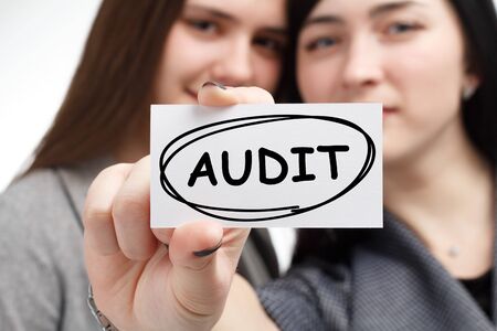 Business, technology, internet and network concept. Young businessman shows a keyword: Audit