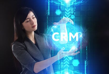 Business, Technology, Internet and network concept. Young businessman working on a virtual screen of the future and sees the inscription: CRMの写真素材