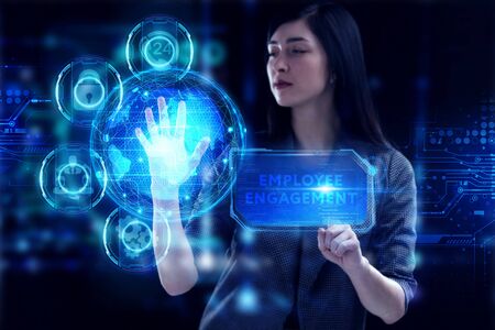Business, Technology, Internet and network concept. Young businessman working on a virtual screen of the future and sees the inscription: Employee engagementの写真素材