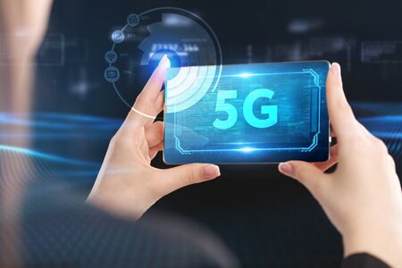 Business, Technology, Internet and network concept. Young businessman working on a virtual screen of the future and sees the inscription: 5Gの写真素材