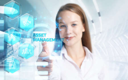 Business, Technology, Internet and network concept. Young businessman working on a virtual screen of the future and sees the inscription: Asset managementの写真素材