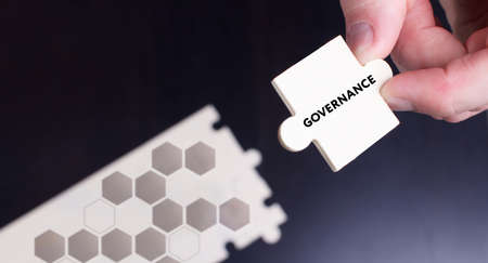 Business, Technology, Internet and network concept. Young businessman shows the word: Governanceの写真素材