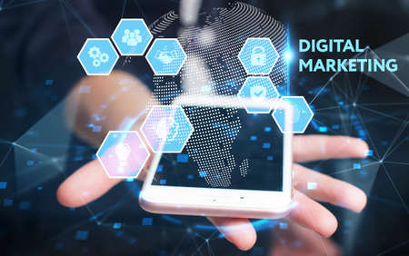 Business, Technology, Internet and network concept. Young businessman working on a virtual screen of the future and sees the inscription: Digital marketingの写真素材