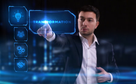 Business, Technology, Internet and network concept. Young businessman working on a virtual screen of the future and sees the inscription: Transformationの写真素材