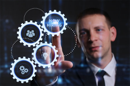 Business, Technology, Internet and network concept. Young businessman working on a virtual screen of the future and sees the inscription: Now hiringの写真素材