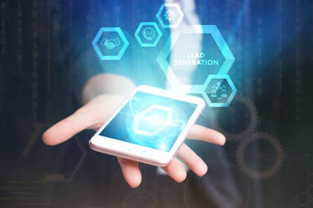 Business, Technology, Internet and network concept. Young businessman working on a virtual screen of the future and sees the inscription: Lead generationの写真素材
