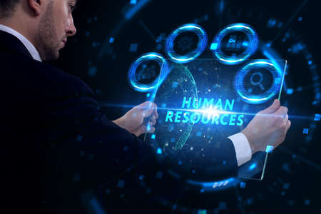 Business, Technology, Internet and network concept. Young businessman working on a virtual screen of the future and sees the inscription: Human resourcesの写真素材