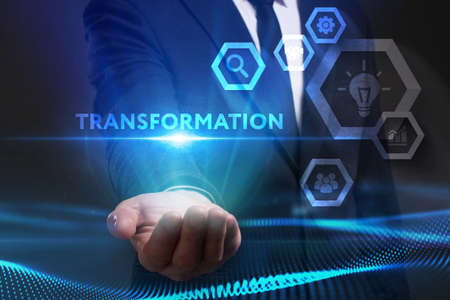 Business, Technology, Internet and network concept. Young businessman working on a virtual screen of the future and sees the inscription: Transformationの写真素材