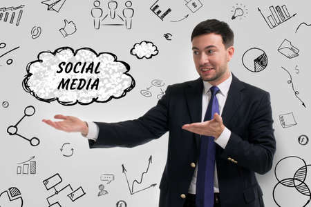 Business, technology, internet and network concept. Young businessman thinks over the steps for successful growth: Social mediaの写真素材