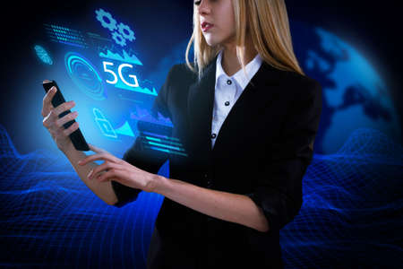 Business, Technology, Internet and network concept. Young businessman working on a virtual screen of the future and sees the inscription: 5Gの写真素材