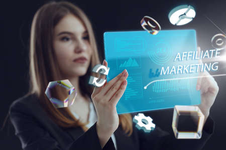 Business, Technology, Internet and network concept. Young businessman working on a virtual screen of the future and sees the inscription: Affiliate marketingの写真素材