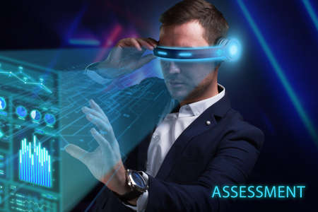 Business, Technology, Internet and network concept. Young businessman working on a virtual screen of the future and sees the inscription: Assessmentの写真素材