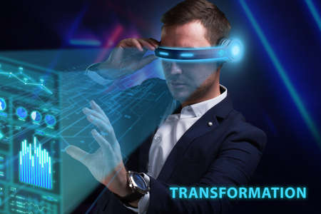 Business, Technology, Internet and network concept. Young businessman working on a virtual screen of the future and sees the inscription: Transformationの写真素材