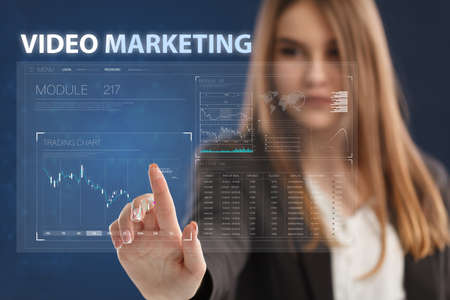 Business, Technology, Internet and network concept. Young businessman working on a virtual screen of the future and sees the inscription: Video marketingの写真素材