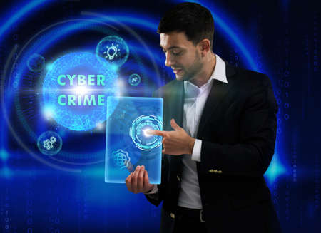 Business, Technology, Internet and network concept. Young businessman working on a virtual screen of the future and sees the inscription: Cyber crimeの写真素材