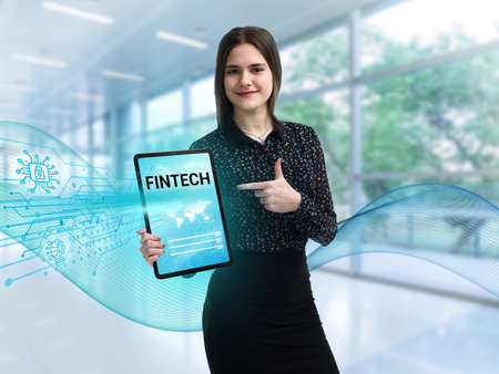 Business, Technology, Internet and network concept. Young businessman working on a virtual screen of the future and sees the inscription: Fintechの写真素材