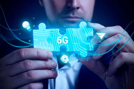 Business, Technology, Internet and network concept. Young businessman working on a virtual screen of the future and sees the inscription: 6Gの写真素材