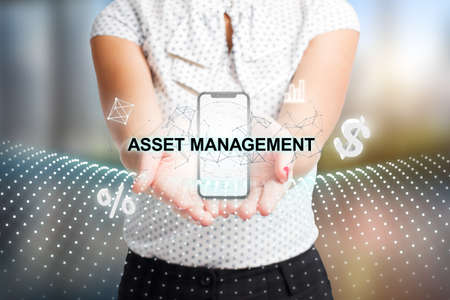 Business, Technology, Internet and network concept. Young businessman working on a virtual screen of the future and sees the inscription: Asset managementの写真素材