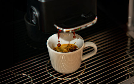 Closeup of espresso pouring from automatic coffee machineの写真素材