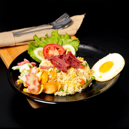 Smoke Beef Fried Rice served with smoke beef, sausage, sunny side up egg and crackersの写真素材