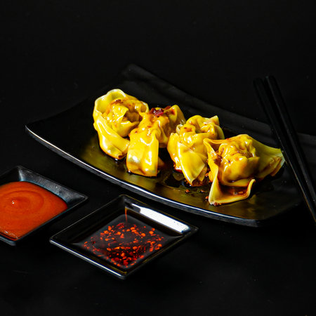 Steamed wonton dumplings stuffed with chicken and shrimp with sauce, Asian food styleの写真素材