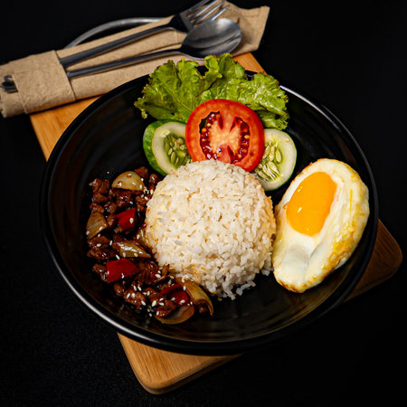 Beef teriyaki rice bowl on wooden cutting boardの写真素材