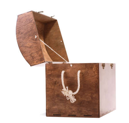 A big dark amber wooden box on isolated background. Spacious antique opened hazel chest with a white...