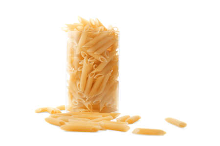 Many pasta in a transparent glass, isolated on a white background. Flour products. Raw pasta in a huge glass, isolated on a white background.の写真素材