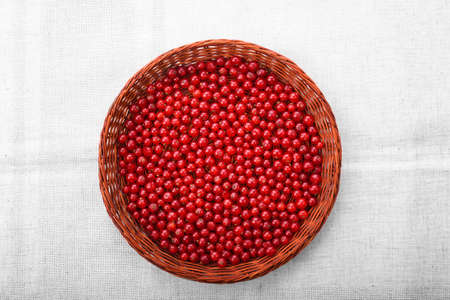 Close-up picture of a brown basket on a silver piece of cloth. A basket filled with tasteful...