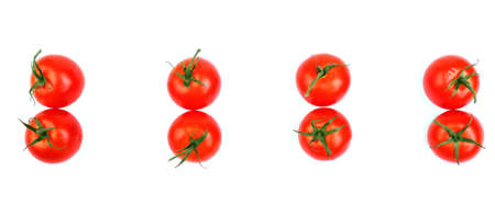 A lot of ripe, organic healthful tomatoes. Many juicy, fresh and bright red tomatoes isolated on a white background. A group of a whole, organic and fresh tomatoes with leaves, top view.の写真素材