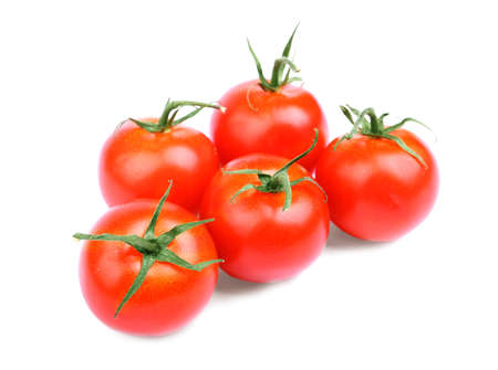 Whole, ripe, juicy, fresh and organic bright red tomatoes with leaves. A lot of an organic, juicy, fresh, healthful bright red tomatoes, isolated on a white background.の写真素材