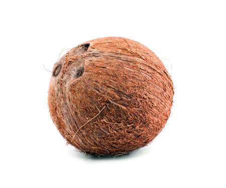 A whole, delicious coconut. Close fresh coconut, isolated on a white background. Tasty tropical coconut. Brown natural tropical and fresh fruit coconut.の写真素材