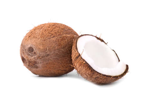 Brown hawaiian coconuts isolated  on a white background. Tasteful white coconut cracked in half and a whole delicious coco. Healthy summer ingredients.の写真素材