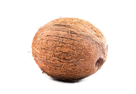 Single tropical brown coconut over a white isolated background. Fresh tasteful whole coco full of vitamins. Delicious organic vegetarian food. Vegan diet.の写真素材