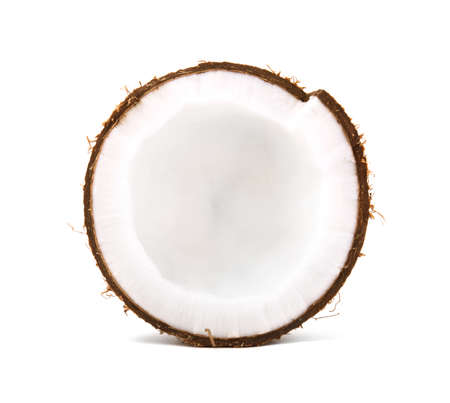 A delicious coconut cut in half in a white isolated background. Cracked bright coco full of nutrients. Organic summer ingredients. Healthy vegan lifestyle.の写真素材