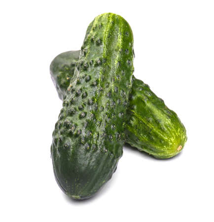 Summer harvest of juicy and ripe cucumbers vegetables. Two whole, juicy and green cucumbers, isolated on a white background. Healthy food.の写真素材