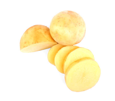 Perfectly chopped fresh potatoes isolated on a bright white background. A whole peeled yellow potato. Delicious vegetables full of starch. Vegetarian lifestyle.の写真素材