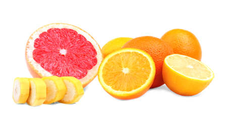 Various colorful summer fruits isolated over the white background. Tasteful scarlet grapefruit cut in half. Little nutritious slices of a banana. Juicy ripe raw oranges.の写真素材