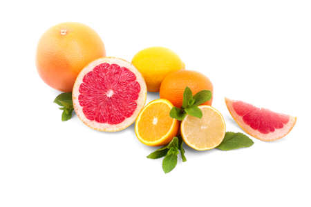 Appetizing juicy summer fruits isolated over the white background. Many colorful oranges, grapefruits, lemons and green mint herbs. Tropical citruses for meals and decoration.の写真素材