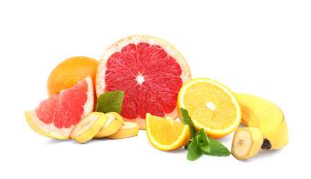 A composition of exotic, organic, fresh and juicy citrus fruits. Organic fruits. Whole and cut healthy, ripe banana, bright and tasty orange, fresh and raw grapefruit with green leaves of mint, isolated on a white backgroundの写真素材