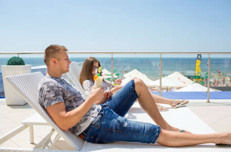 Happy honeymoon vacation at paradise hotel. A couple relaxes near the beach. Happy sea lifestyle. Young family, man and woman rest on the beach of ocean. Couple in love. Summertime.の写真素材